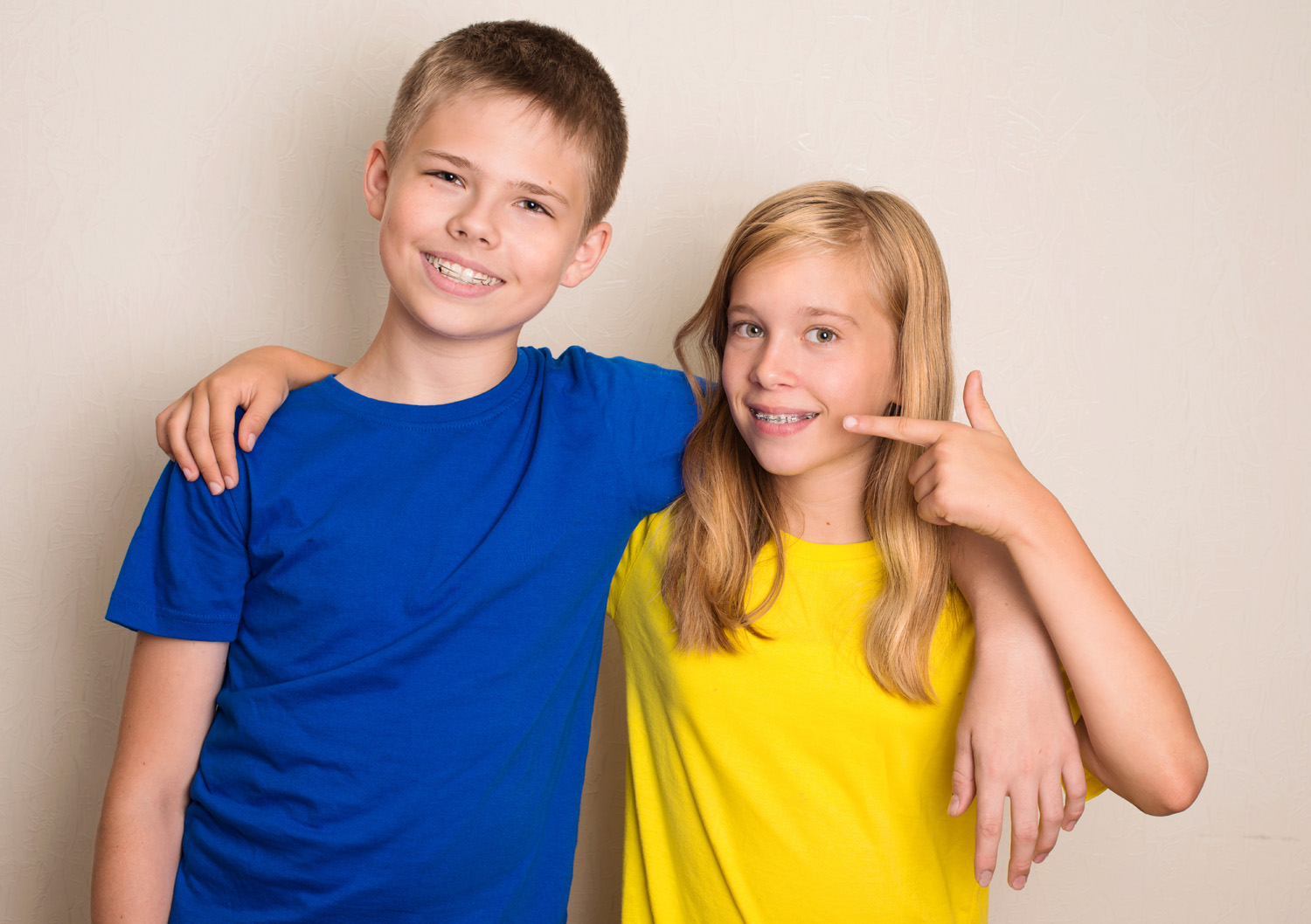 Smiling teens with different kinds of dental brace showing  thumb up gesture. Healthcare health and people concept.