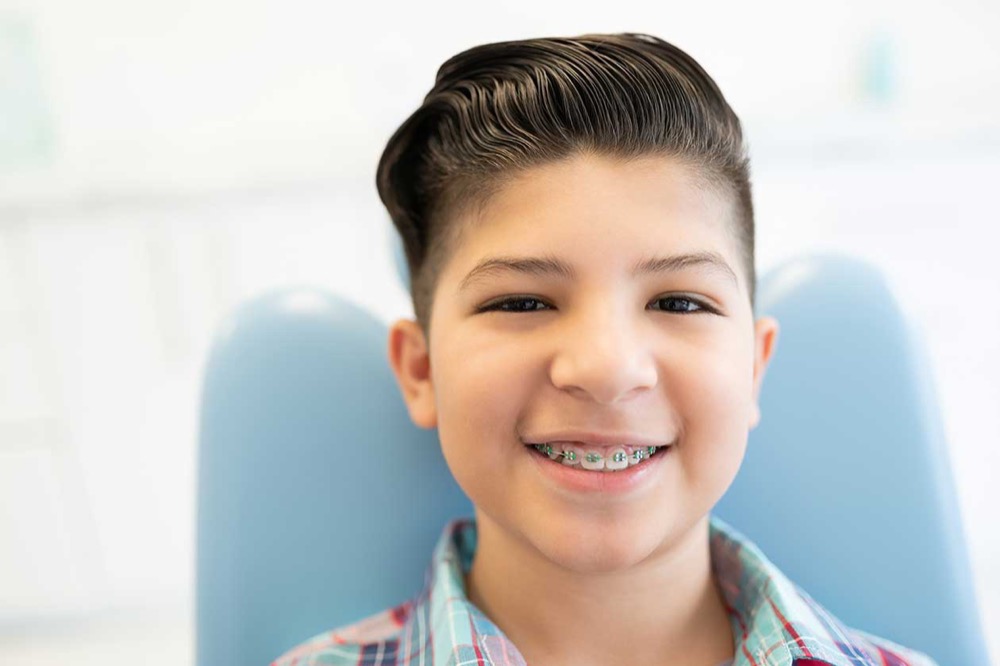 Child receiving early orthodontic care to guide healthy smile development in Claremont